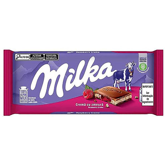 Milka Raspberry Creme 100g chocolate bar packaging with iconic purple background, displaying Milka logo, fresh raspberries, and a piece of chocolate with creamy filling.